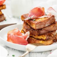 Turkey Bacon, Egg & Cheese French Toast Sandwich · Delicious breakfast sandwich served between two slices of golden french toast. Filled with c...