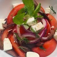 Tomato Feta Salad · Tomato, feta cheese, red onion, Kalamata olives, fresh mint, olive oil, sea salt