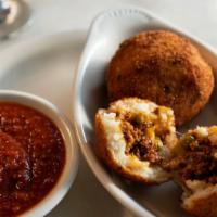 Arancini Con Carne · Three lightly fried rice balls stuffed with ground beef and green peas, with marinara sauce.