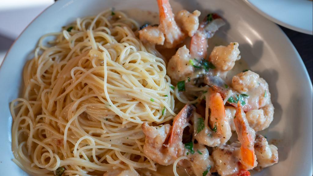 Shrimp Scampi · Over angel hair pasta in a white wine, butter, garlic sauce bath.