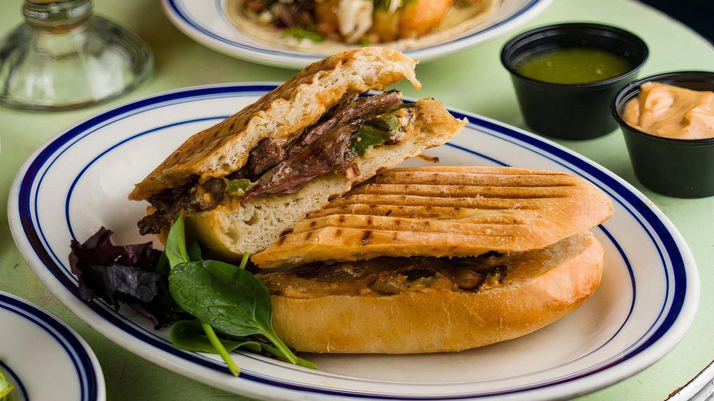 Grilled Steak Torta · Marinated skirt steak, fried onions, peppers & chipotle mayo.