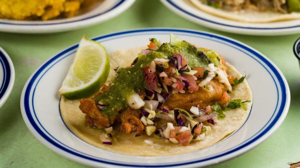 Baja Style Fish Taco · Beer battered white fish, shredded cabbage pico mix & salsa verde.