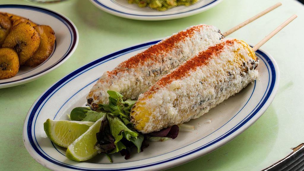 Grilled Corn · WORLD FAMOUS GRILLED CORN! Mayo, cotija cheese, chili powder & lime