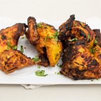 Chargha Tamam · Our signature item.  Whole chicken marinated in herbs and spices and perfectly grilled in cl...