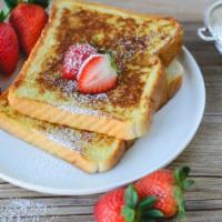Strawberry French Toast Deluxe · Fresh french toast with strawberries topped with syrup and choice of meat on side.