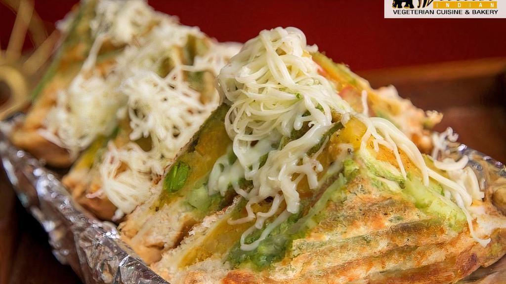 Vegetable Cheese Sandwich · Jain. 3 layers of breads stuffed with potato, cucumber, onion and tomato with green mint and red garlic chutney garnished with Amul cheese.