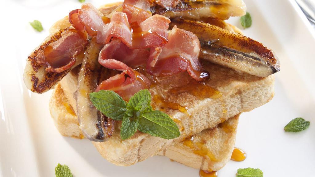 Ultimate Bacon French Toast With Syrup · Delicious french toast made with cinnamon, eggs, and vanilla extract comes with crispy bacon, served with syrup.