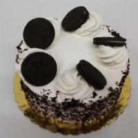 Round Oreo Cake · Chocolate Cake w/ Oreo Filling w/Whipped Cream Icing and Oreo Cookies on top.