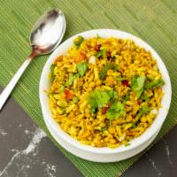 Bhel Puri · Bombay style mix of puffed rice, crispy sev, rice flour crisps, peanuts, onions, tomatoes, ...