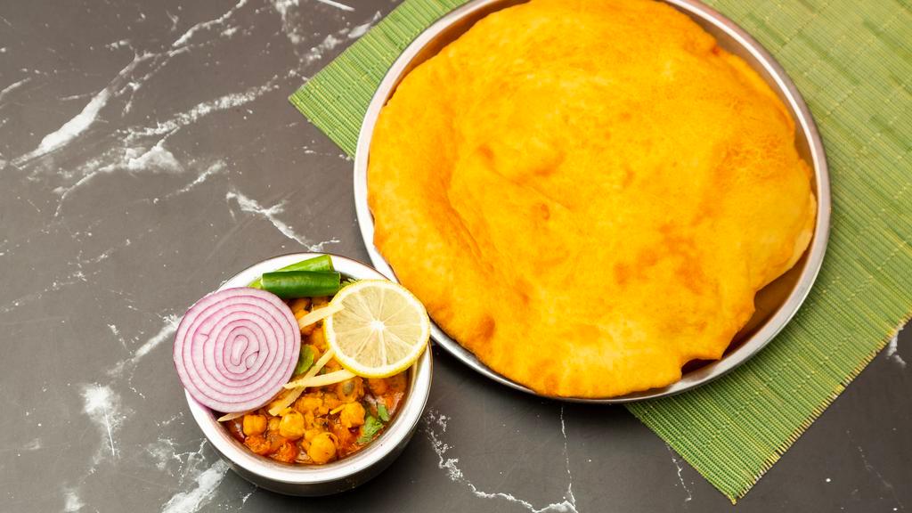 Chana Bhatura · Not Gluten-Free. Large puffed bread made of all-purpose flour
served with chickpeas and spicy curry.