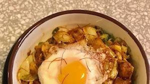 Buta Kimchi Rice Bowl · Sauteed kimchi and pork over rice with sunny side egg on top.