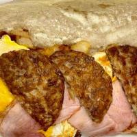 Hungry Man Hero · Three eggs, bacon, ham, sausage, cheese and home fries on a hero.