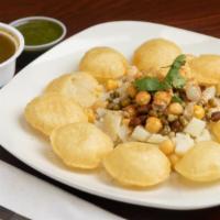 Pani Poori · Crispy pooris. Served with spiced potatoes, moong, chutney, and spiced water.