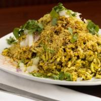 Bhel Poori · Crispy rice puffs topped with onions, potatoes, chutney, and spices.