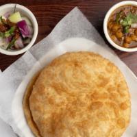 Chole Bhature · A savory chickpea curry in a tomato and onion gravy. Served with indian puffed bread.