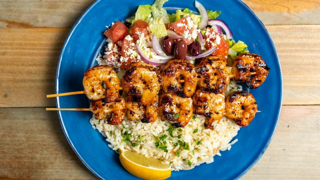 Shrimp Souvlaki (2 Pc) · Sticks of grilled shrimp seasoned with herbs. Includes a choice of rice or fresh cut fries, with side horiatiki house salad, one pita & a side tzatziki (2 oz)