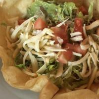 Taco Salad · Chicken or beef with rice, beans, guacamole, sour cream, lettuce, cheese and tomato in a flo...