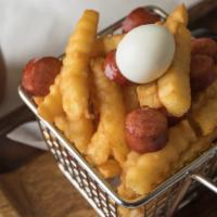 Salchipapas · Thinly sliced pan-fried beef sausages with French fries and quail egg.