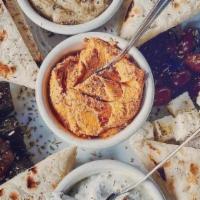 Krya Pikilia · An assortment of traditional Mediterranean spreads. Served with grape leaves, olives and fet...
