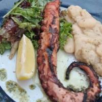 Oktapodi Scharas · Marinated tender octopus grilled to perfection and served with lima beans and cooked with ba...