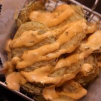 Fried Pickle Chips · Dusted in flour, served with Russian dressing for dipping