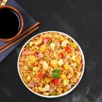 Pineapple Fried Rice · Stir-fried rice with pineapple, cashew nut, tomato, and onion with vegan Thai seasoning.