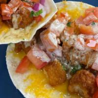 The Honey Dip Taco · A soft shell taco with fried chicken, melted monterey jack/cheddar cheese, pico de gallo, ho...