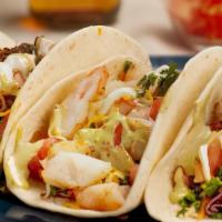 The Classic Taco · Choice of hard or soft shell taco with shredded monterey jack/cheddar cheese, power slaw, to...