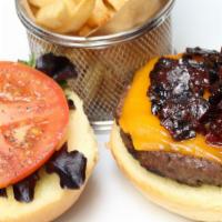 Wagyu Beef Burger · On a brioche bun with French fries.