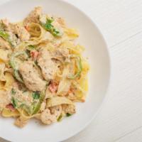 The Cajun Chicken Pasta · Fresh bowl of pasta made with cajun chicken, vodka sauce and parmesan cheese on a bed of fre...