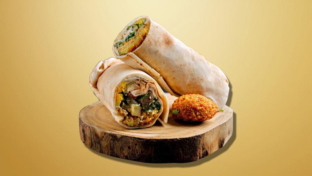 Falafel Fury Wrap · Falafel on a pita with fresh veggies, tahini sauce, rolled and toasted in a panini grill