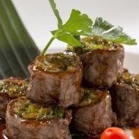Beef Negimaki · Broiled beef rolled with scallion and teriyaki sauce.