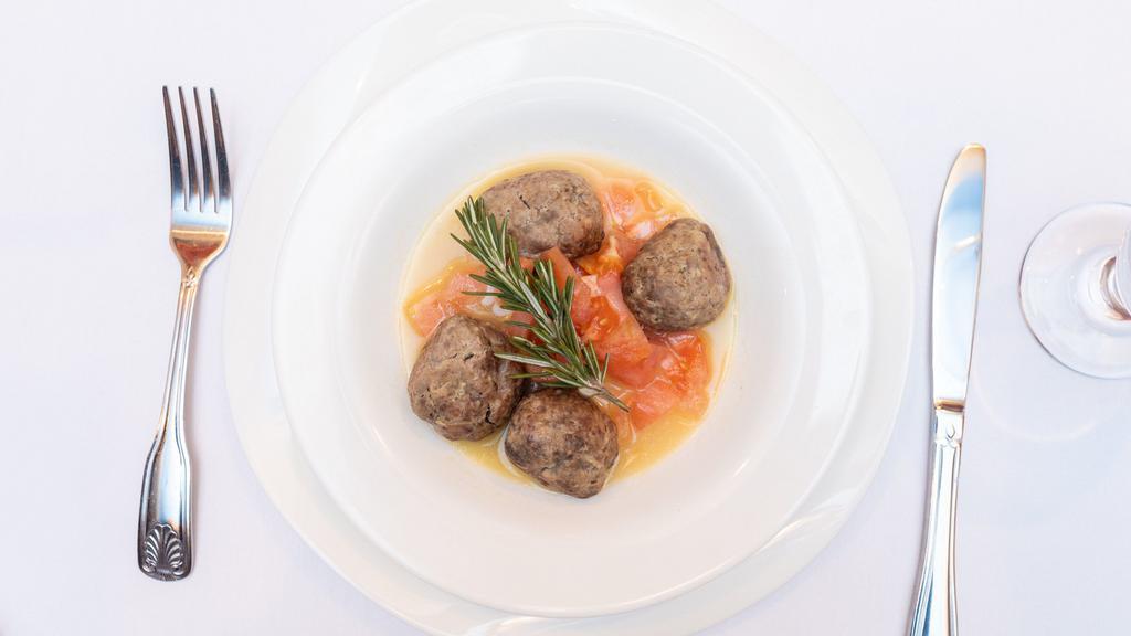 Polpettone Della Nonna · Lamb meatballs in a lemon and rosemary sauce served with marinated fresh tomatoes