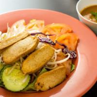 House Salad · A variety of fresh garden greens with tomatoes, onions, carrots, cucumbers and fried tofu se...
