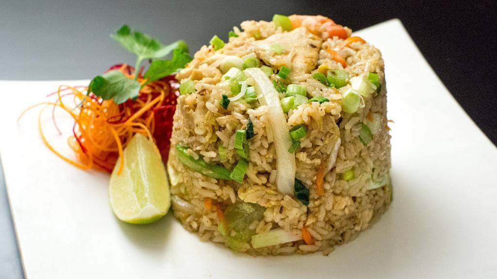 Thai Fried Rice · Stir fried rice with scallions, onions, tomatoes, carrots, and egg.