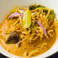 Kow Soi (Curry Noodle Soup) · Hot. Spicy. Northern Thai style egg noodle in curry sauce with red onions, and dried shallot...