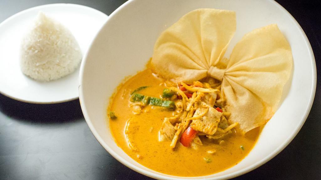 Red Curry · Hot. Spicy. Spices cooked in red chili paste with bamboo shoots, fresh basil and bell peppers. Simmered in coconut milk.