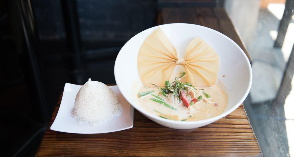 Panang Curry · Hot. Spicy. Spices cooked in panang curry paste with string beans, bell peppers, and kaffir lime leaves. Simmered in coconut milk.