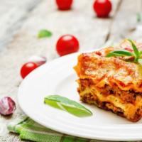 Lasagna With Meat Sauce · Layered noodles filled with ricotta cheese and house made hearty meat sauce.