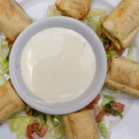 Mini Chimichangas · Six mini chimichangas with choice of shredded chicken or shredded beef served with cheese dip.