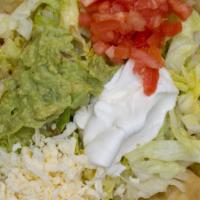 Taco Salad · Crispy flour tortilla shell topped with chicken or beef, lettuce, shredded cheese, sour crea...