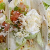 Baja Tacos · Three shredded chicken or ground beef soft flour tacos with lettuce, pico de gallo, sour cre...