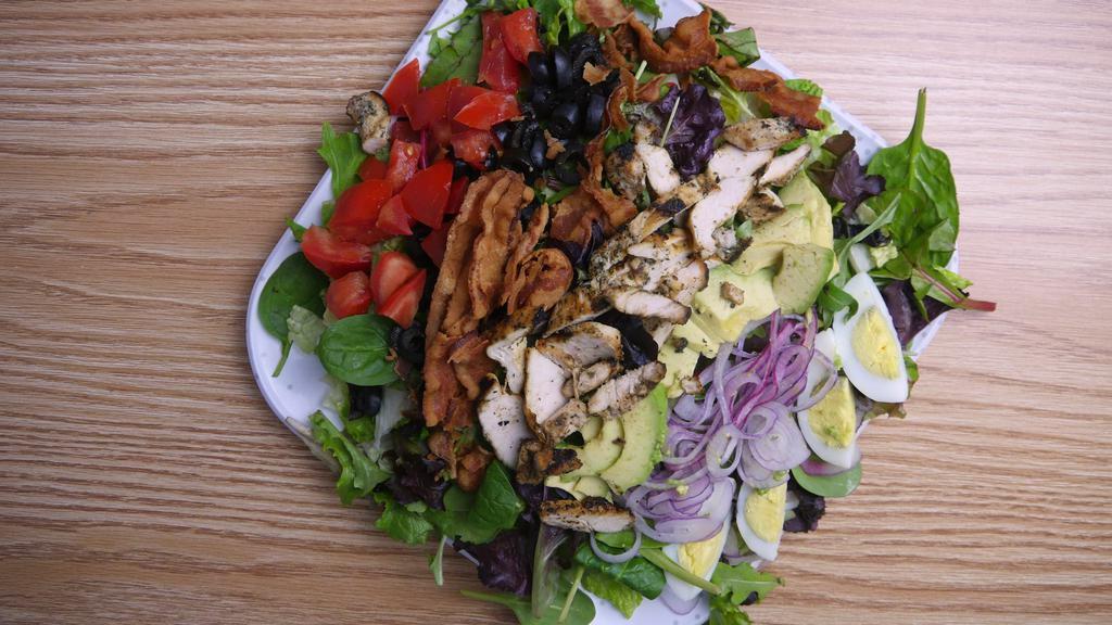 Grilled Chicken Cobb Salad · Grilled chicken, romaine lettuce, chopped bacon, diced tomato, red onion, avocado, sliced pepper jack, and chopped black olives.