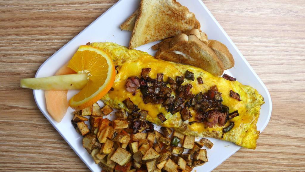 Western Omelette · Ham, peppers and onions, cheddar cheese with home fries and toast.