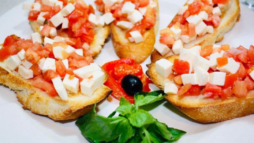 Bruschetta Crostini · Chopped tomatoes, garlic, basil, olive oil on toasted Italian bread.