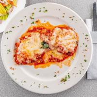 Chicken Parmigiana Over Linguini  · Served over linguini pasta tomato sauce