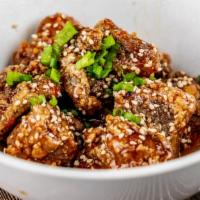 Sweet Chili Spare Ribs · Marinated spare ribs, fried to perfection, tossed with sweet chili sauce, and topped with se...