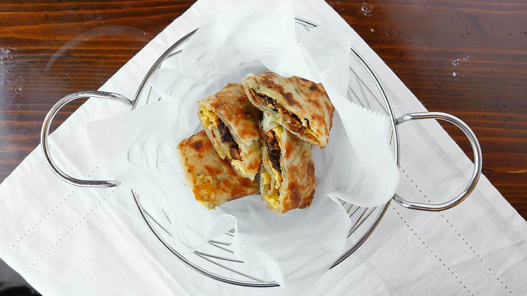 Scallion Pancake Dried Pork Roll With Egg · Dried pork, Hoisin Sauce, and Egg that is rolled into a crispy piece of scallion pancake.