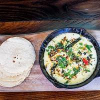 Queso Fundido · pepper jack cheese, poblano peppers & warm tortillas.