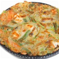 Seafood Jeon · Korean pan cake with mussels, prawns, squid, pepper, carrot and spring onion.